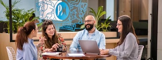 colleagues seating round a table