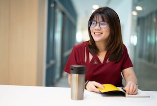 Smiling women writing in notepad