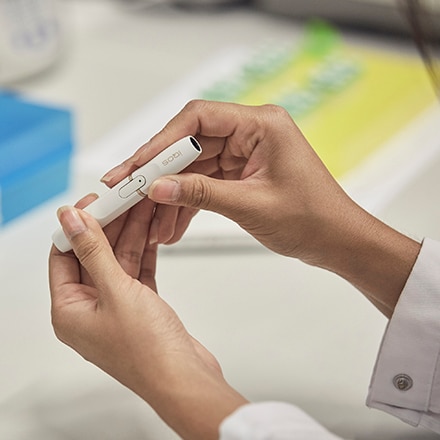 Scientist holding IQOS originals