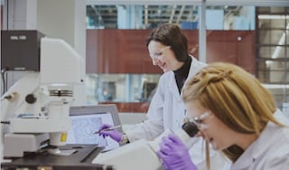 Two female researchers conducting scientific research