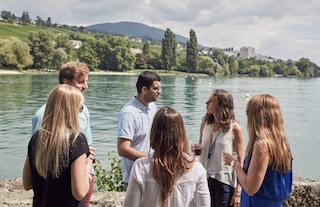 Group of people socializing by a lake