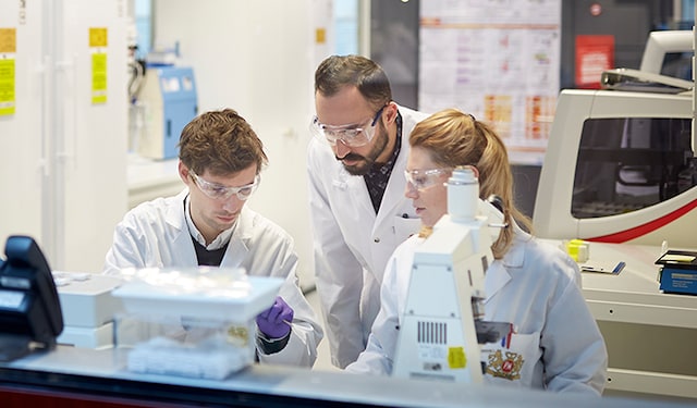 Three scientists in a PMI laboratory in Neuchatel, Switzerland