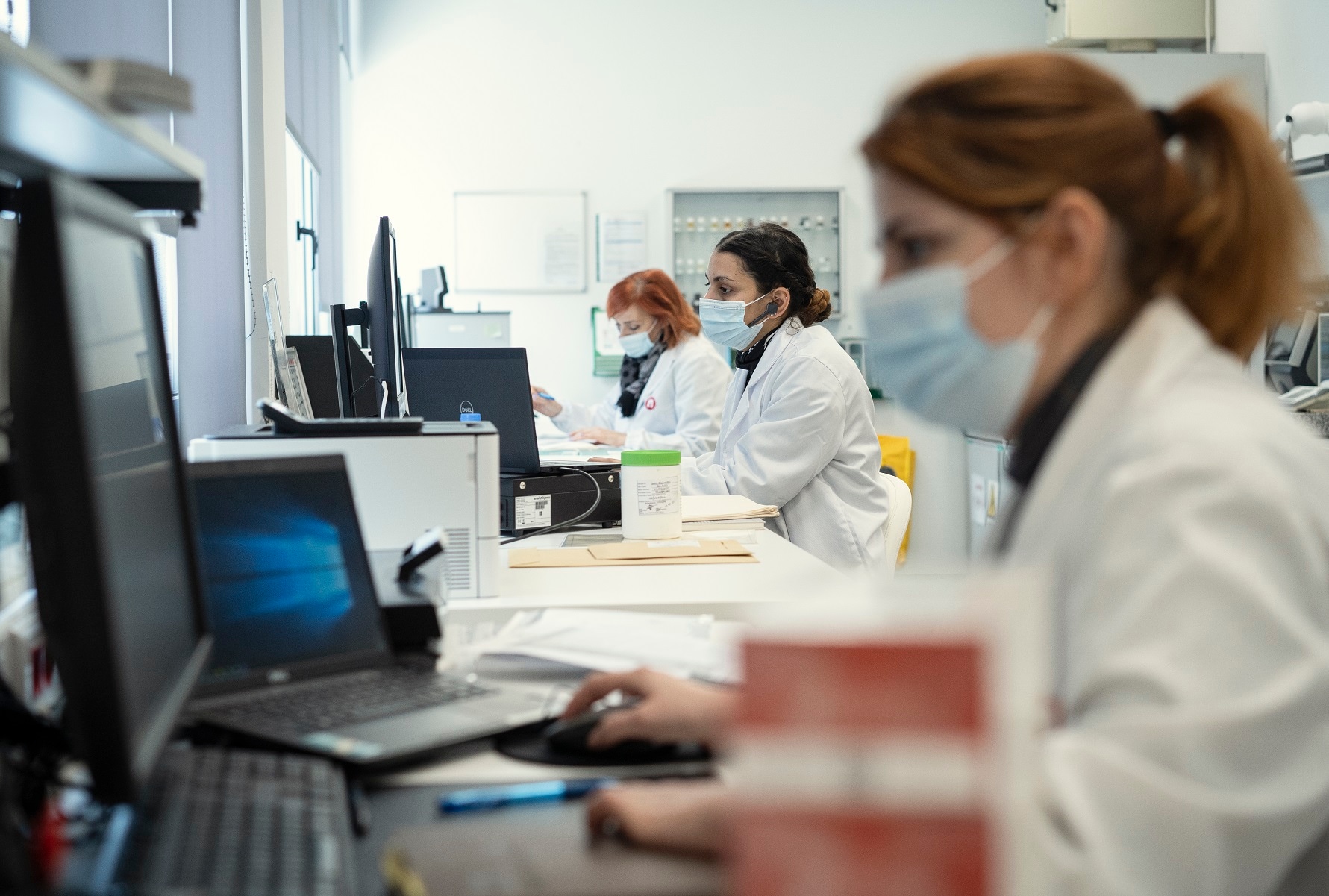 Scientists wearing masks in a laboratory