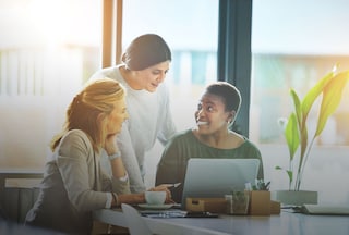 Three women talking in an office