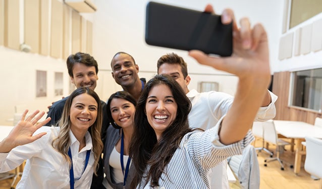 Group of friends taking a selfie in the office